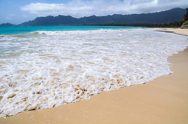 Surf rushes on to the soft sand beach in Waimanalo, Hawaii on the eastern shore of Oahu.