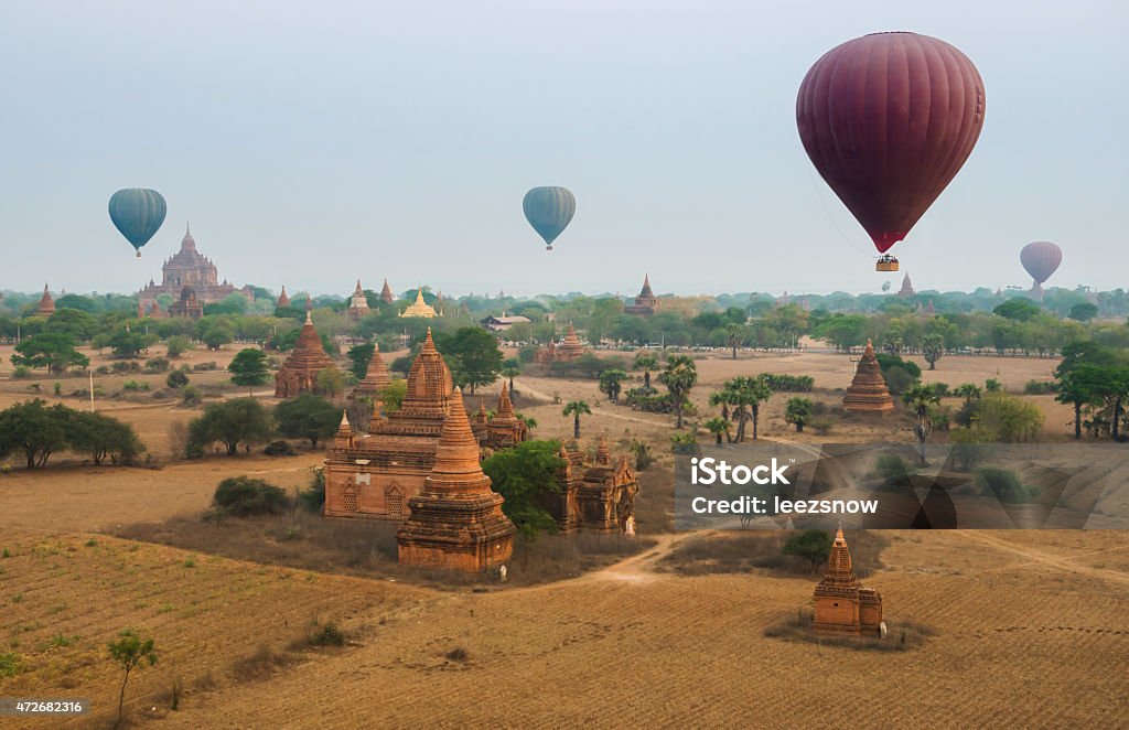 Hot Air Balloons Over The Temples of Bagan Several hot air balloons take flight over the temple ruins of Bagan, Myanmar, just before sunrise. 2015 Stock Photo