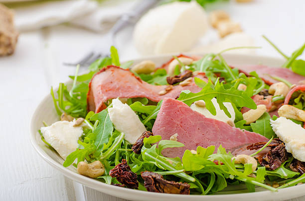 istock Arugula salad with meat and mozzarella 472683006
