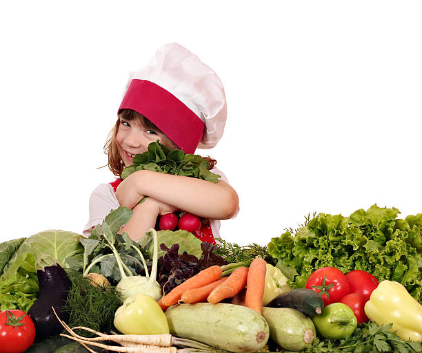 istock happy little girl cook with vegetables 472683862