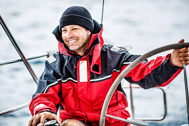 feliz skipper no barco à vela - travel locations sea mediterranean sea wind - fotografias e filmes do acervo