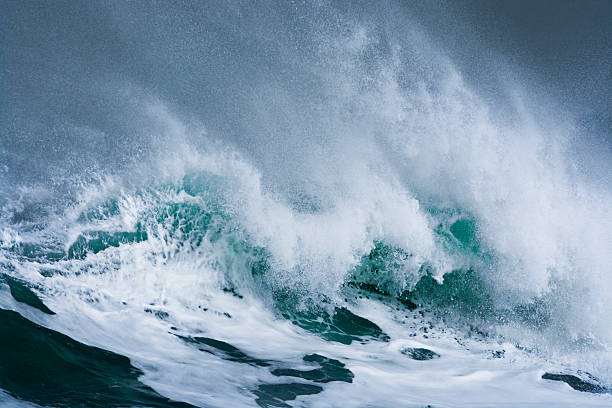 istock Detailed storm wave breaking and splashing on shore 472684216