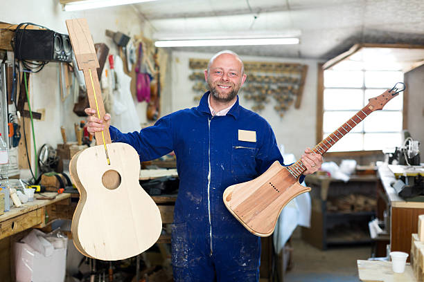 istock craftsman working with unfinished guitar 472685064