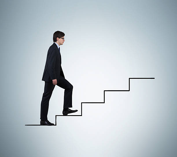 istock businessman walking on stairs 472685514