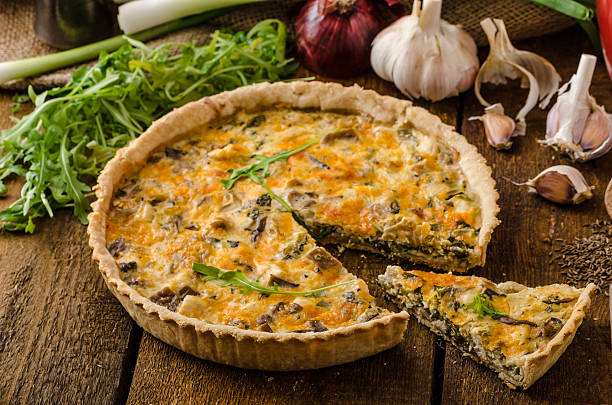 istock A cheese quiche with chicken, arugula, and garlic on a table 472685874