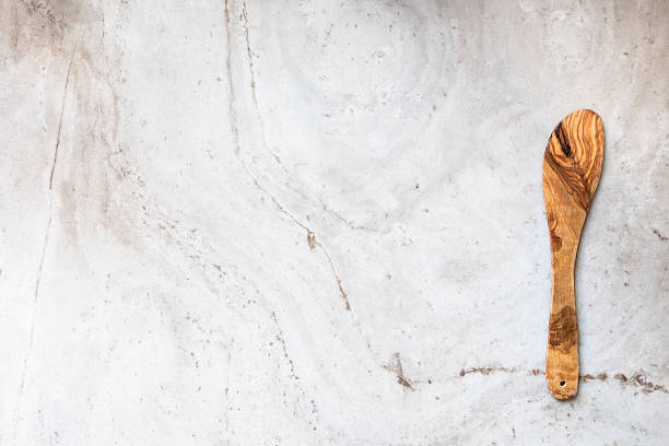 istock Wooden spoon on marble slab 472685990