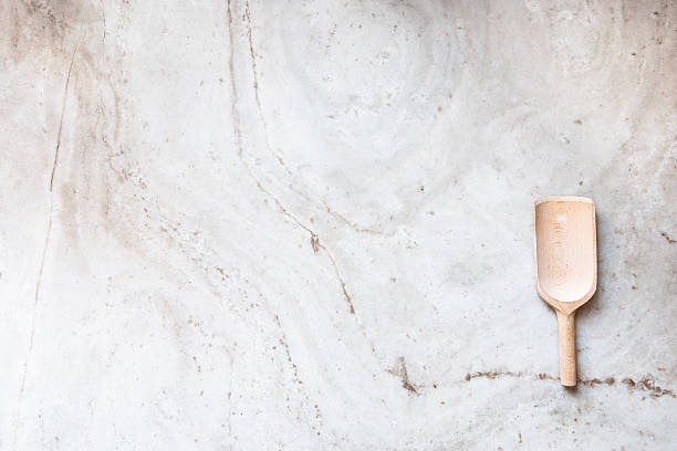 istock Wooden spoon on marble slab 472686516