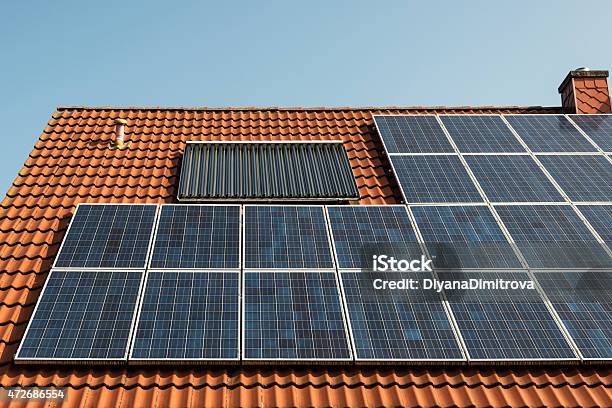 Solar Panel On A Red Roof Stock Photo - Download Image Now - 2015, Biological Cell, Blue