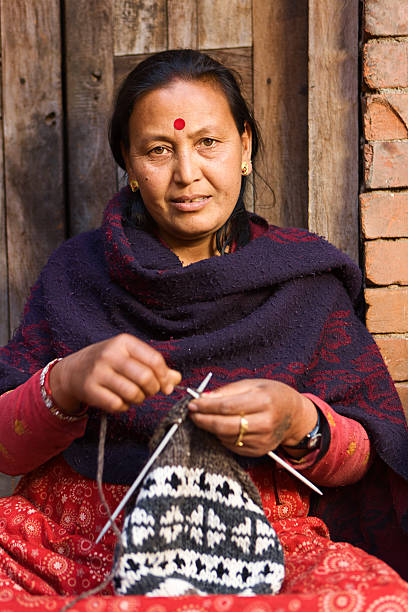 istock Nepali woman kniting wool hat. Bhaktapur. 472687932