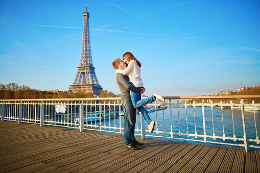 Romantic couple having fun near the Eifel tower and kissing