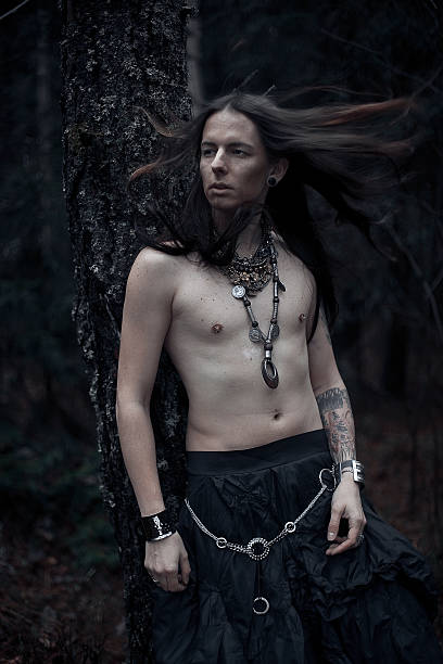 istock man with long hair in the dark forest 472690486