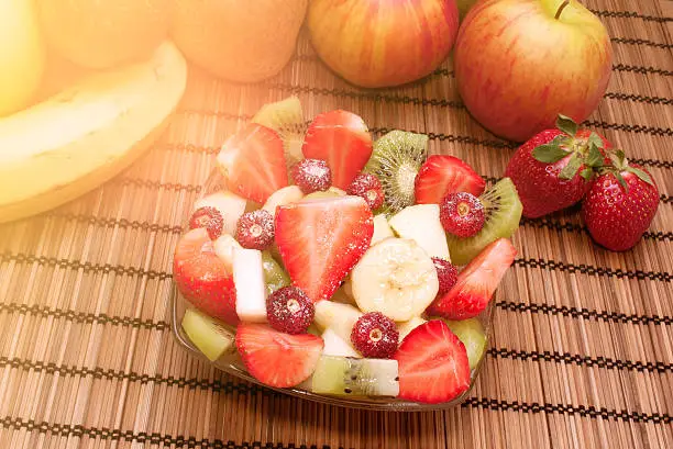 Diet healthy fruit salad in glass bowl healthy breakfast weight loss concept warm filter applied