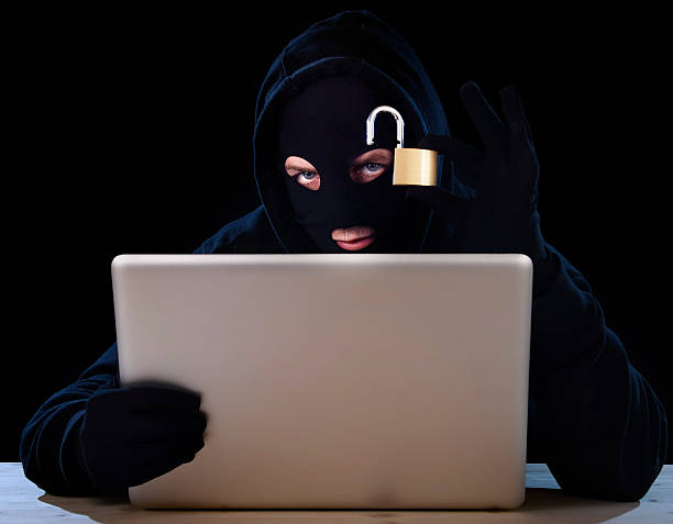 istock digital criminal hacker with computer lock in cyber crime concept 472693040