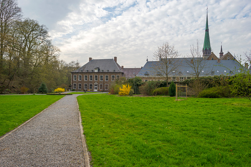 Footpath through the park of an abbey in spring