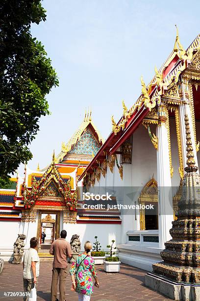 Temple And Tourists Doing Sight Seeing In Wat Pho Stock Photo - Download Image Now - 2015, Adult, Architecture