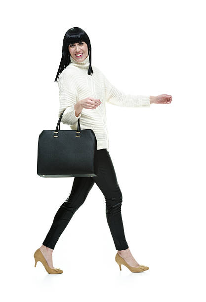 istock Cheerful woman walking and looking at camera 472694298