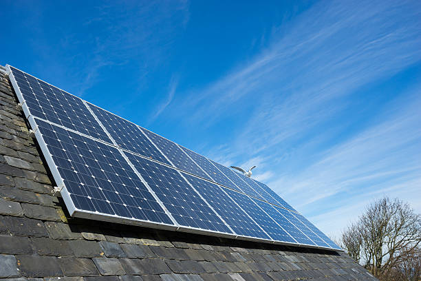 istock solar cell panel on house's roof, green energy 472695574