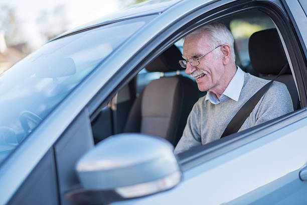 istock Senior man driving a car 472695690