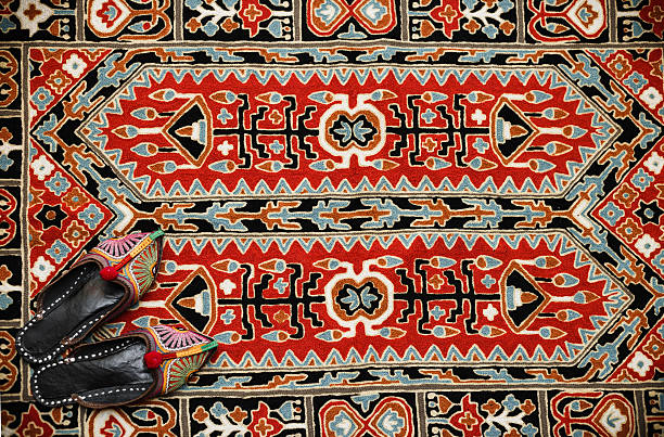 Asian interior. Carpet and slippers stock photo