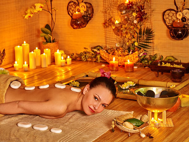 istock Woman getting stone therapy massage 472696570