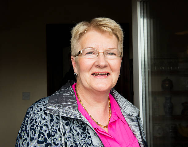 istock Smiling senior woman at doorway 472697592