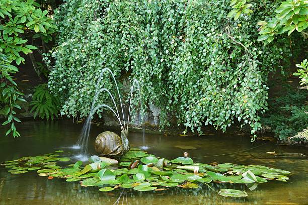 Garden pond with a snail fountain, Butchart Gardens