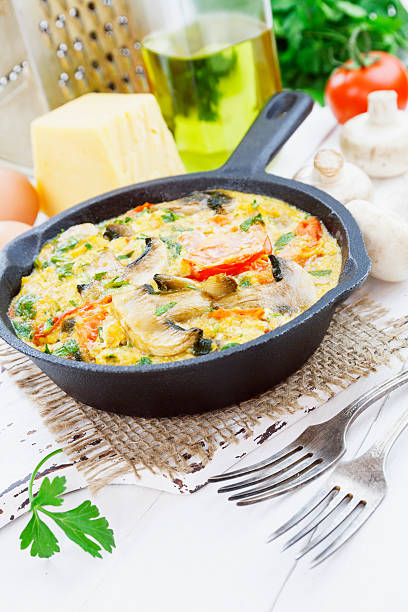 istock Omelet with mushrooms and tomatoes. Frittata 472697990