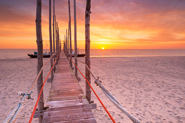 istock Seaside jetty at sunrise on Texel island, The Netherlands 472698184