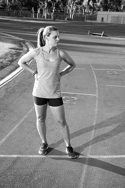 istock Female runner on an athletics track 472698494