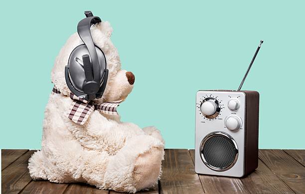 istock Retro toy Teddy Bear and radio receiver front mint green 472698582