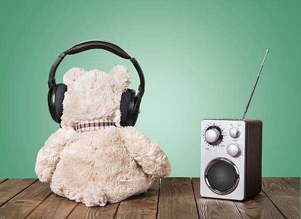 istock Retro toy Teddy Bear and radio receiver front mint green 472698586