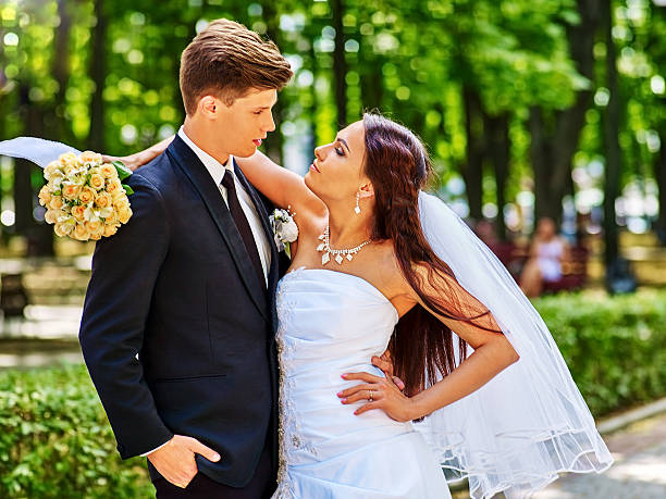 istock Bride and groom with flower outdoor 472699366