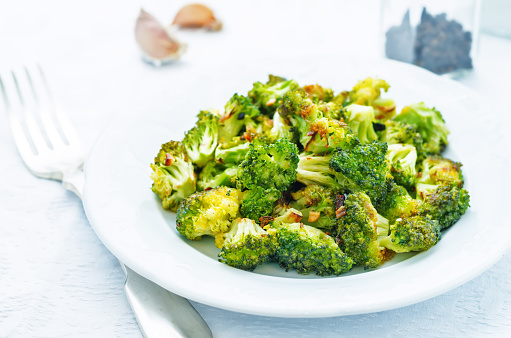 roasted broccoli with garlic on a white background. the toning. selective focus