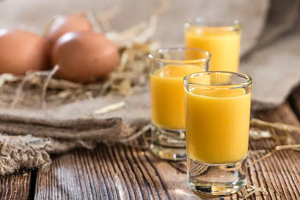 Homemade Egg Liqueur on dark vintage wooden background