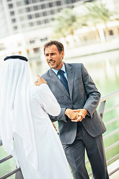 istock Emirati doing business with western businessman 472704342