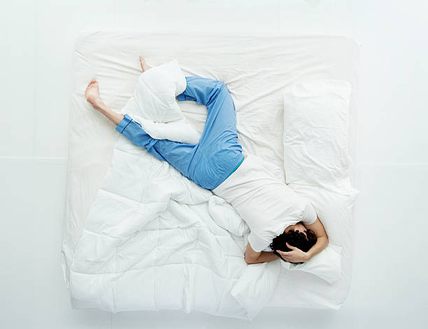 istock Above view of man sleeping on bed 472705112