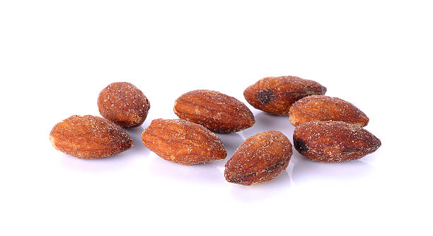 istock salted and roasted almonds on white background 472706768