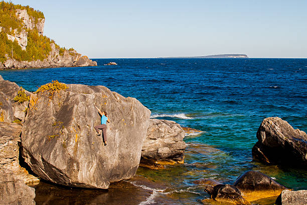 istock Lone woman climbing 472707052