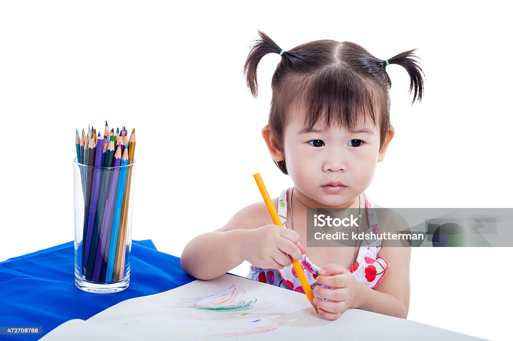 Child imagine to draw picture Little asian (thai) girl imagine to draw picture at the table with images paper and color pencils, isolated on white background 2-3 Years Stock Photo