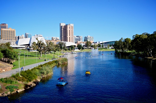 View of Elder Park in Adelaide and River Torrens scattered with paddle boats.