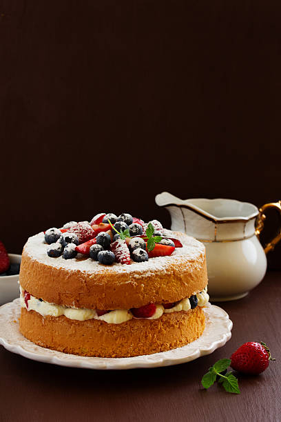 istock Genoise (cake) with cream, berries and lemon cream. 472711034