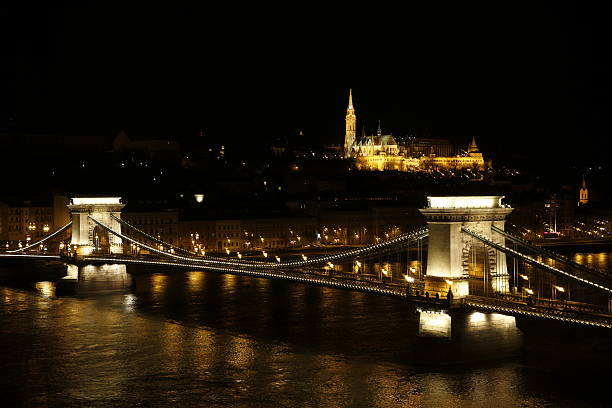 Budapest Chain Bridge and Matthias Church at night Budapest Chain Bridge and Matthias Church captured opposite the river Danube from a unique high building at night. arma-globalphotos stock pictures, royalty-free photos & images
