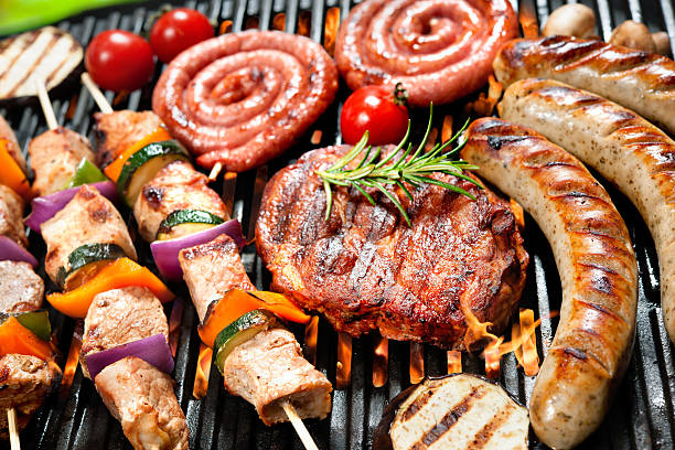 istock Close-up of various meat products on a grill 472711584