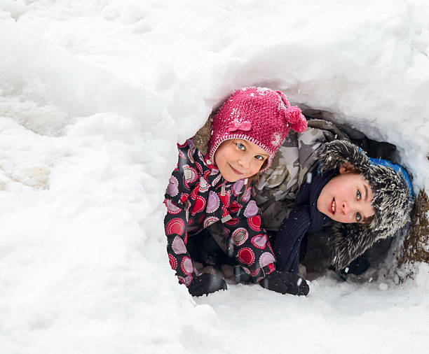 istock Children playing in a snow cave 472714550