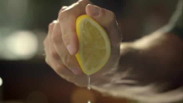 Man squeezing lemon