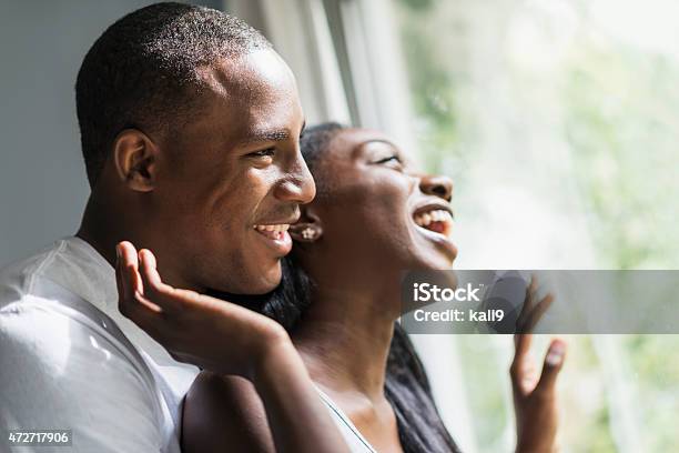 Faces Of Young Black Couple Looking Out Window Laughing Stock Photo - Download Image Now