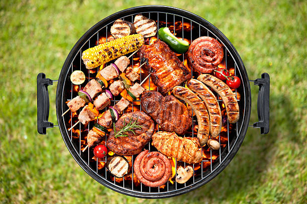 istock Various meats and vegetables being cooked on a grill 472719548