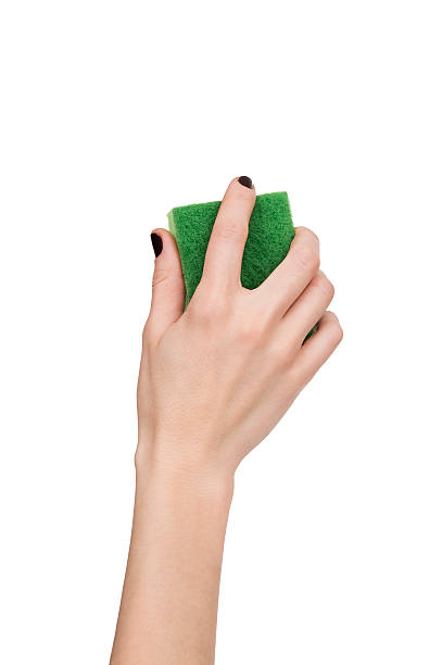 istock woman hand holding green sponge isolated over white 472720208