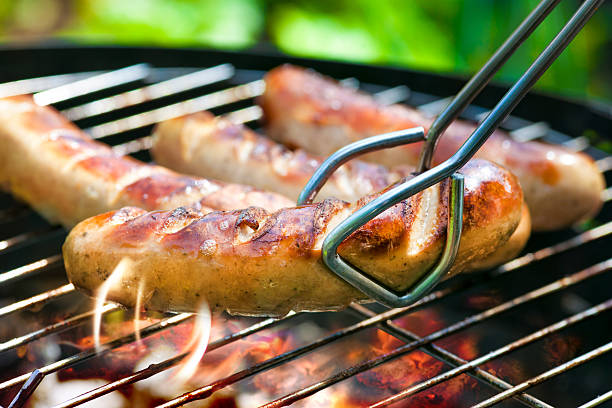 Grilled Sausage Delicious german sausages on the barbecue grill sausage stock pictures, royalty-free photos & images