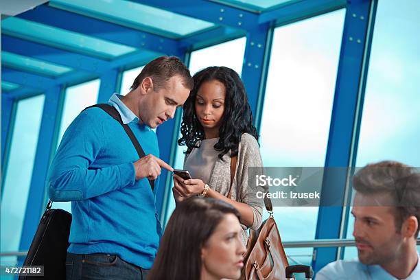 People At The Airport Lounge Using Smart Phone Stock Photo - Download Image Now - 2015, Adult, African Ethnicity